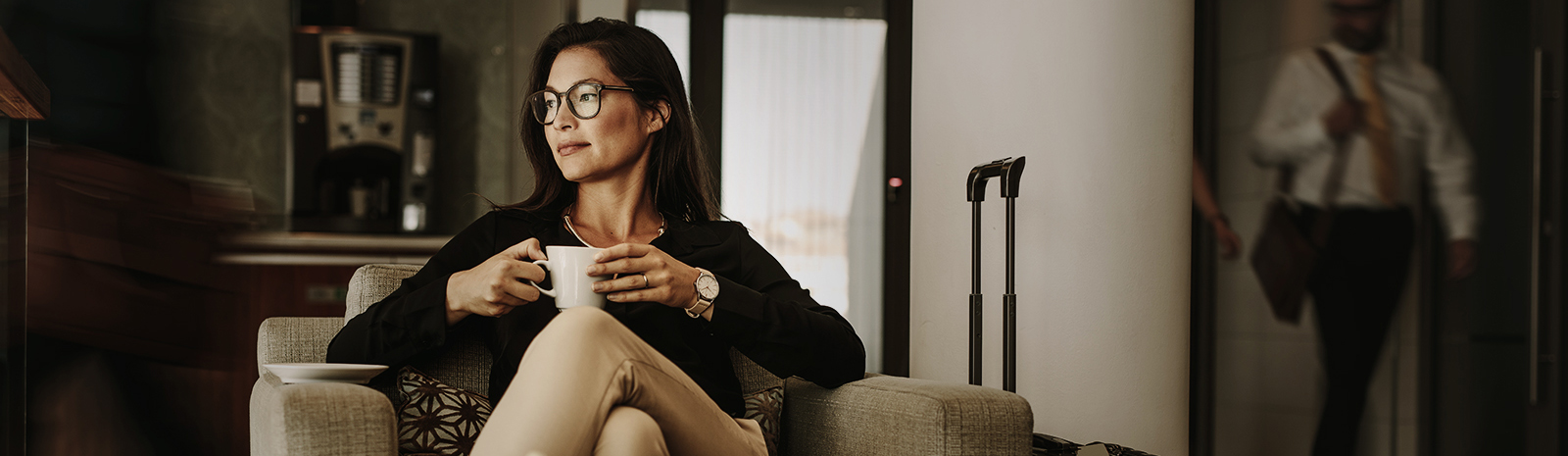 woman at airport holding a coffee