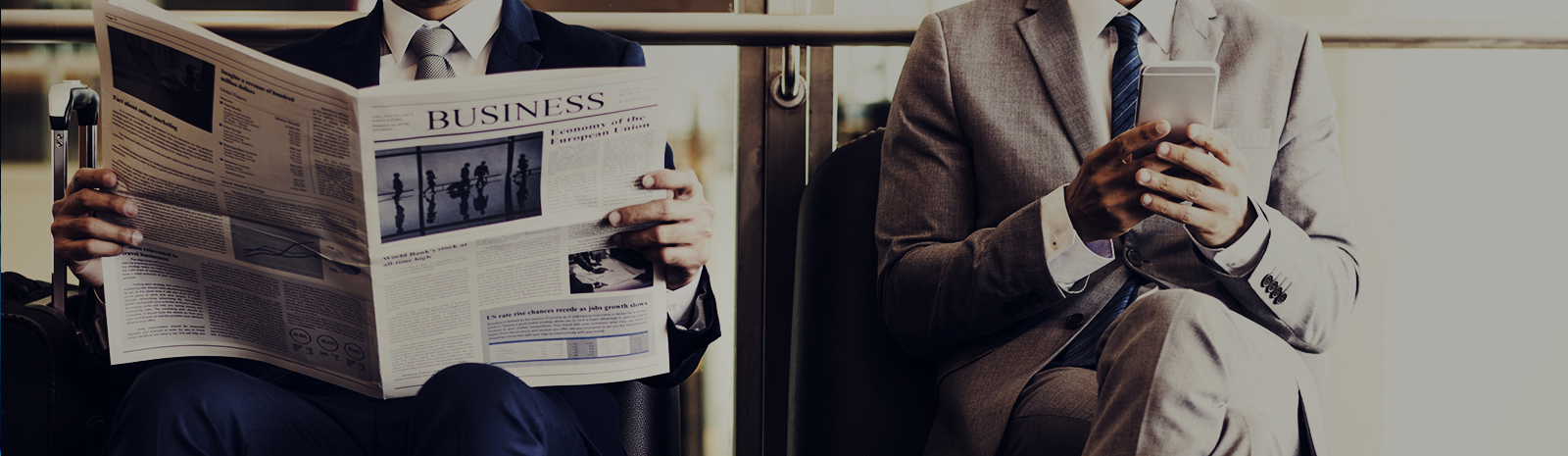 two men reading a newspaper