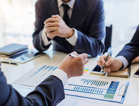 three business men looking at work plans