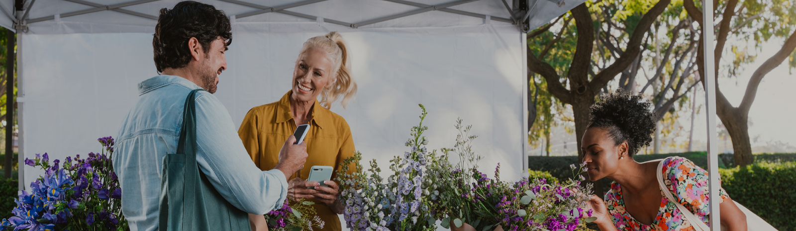 photo of two females and 1 male at a pop-up flower shop
