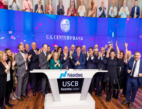 US century bank employees celebrating at Nasdaq